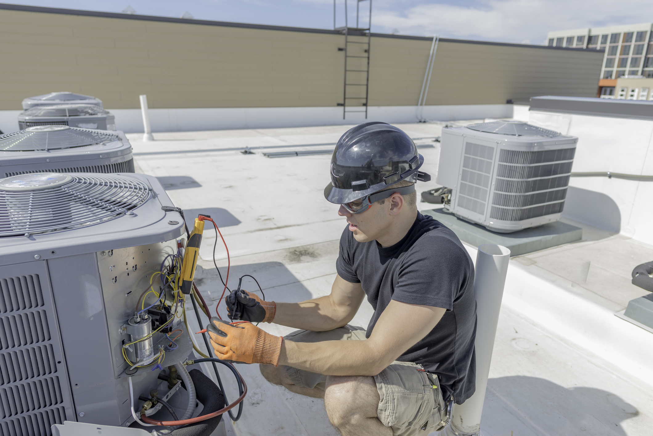 HVac Technician working on condenser panel